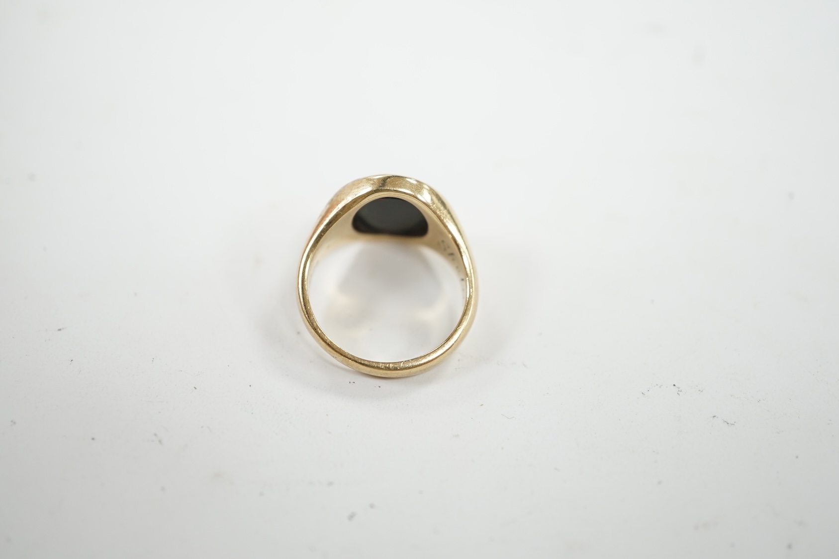 A 9ct gold and bloodstone set signet ring, with carved initial and interior inscription, size J/K, gross weight 5.9 grams. Condition - poor